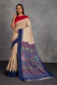 Shop beautiful beige tussar silk sari online in USA with blue weave pallu. Get festive ready in beautiful Kanchipuram silk saris, pure silk sarees, soft silk sarees, tussar silk saris, handwoven sarees, chanderi silk sarees from Pure Elegance Indian fashion store in USA.-full view