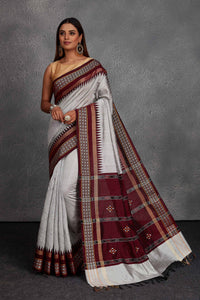 Shop beautiful light grey tussar silk sari online in USA with maroon temple border. Get festive ready in beautiful Kanchipuram silk saris, pure silk sarees, soft silk sarees, tussar silk saris, handwoven sarees, chanderi silk sarees from Pure Elegance Indian fashion store in USA.-full view