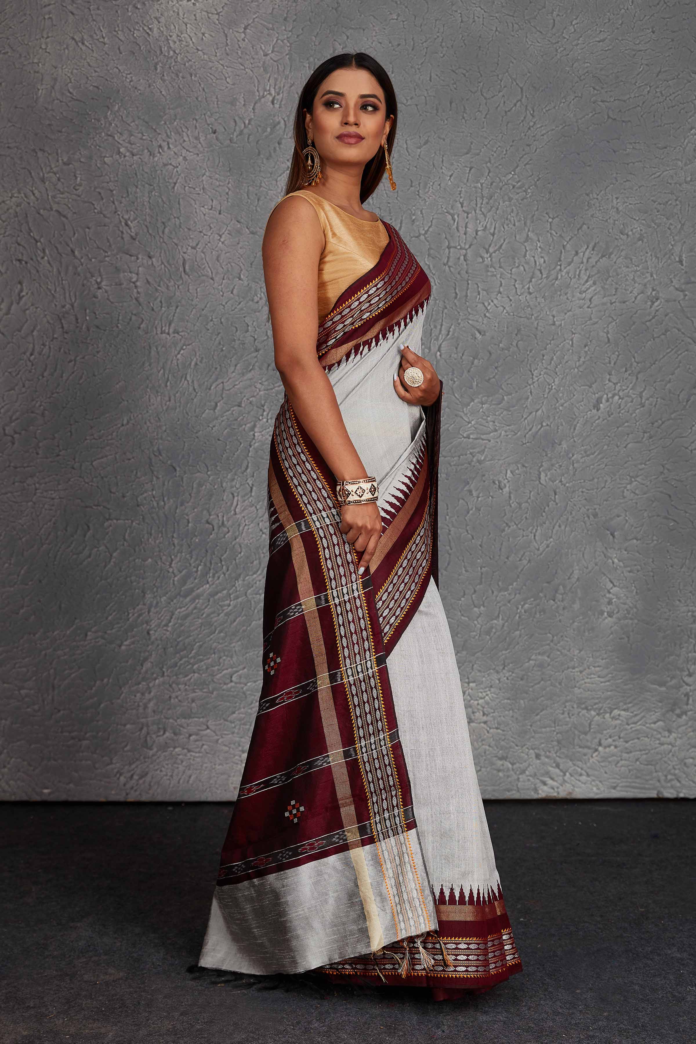 Shop beautiful light grey tussar silk sari online in USA with maroon temple border. Get festive ready in beautiful Kanchipuram silk saris, pure silk sarees, soft silk sarees, tussar silk saris, handwoven sarees, chanderi silk sarees from Pure Elegance Indian fashion store in USA.-side