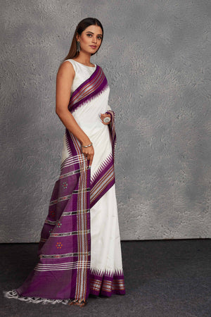Shop white tussar silk sari online in USA with purple border and pallu. Get festive ready in beautiful Kanchipuram silk saris, pure silk sarees, soft silk sarees, tussar silk saris, handwoven sarees, chanderi silk sarees from Pure Elegance Indian fashion store in USA.-side