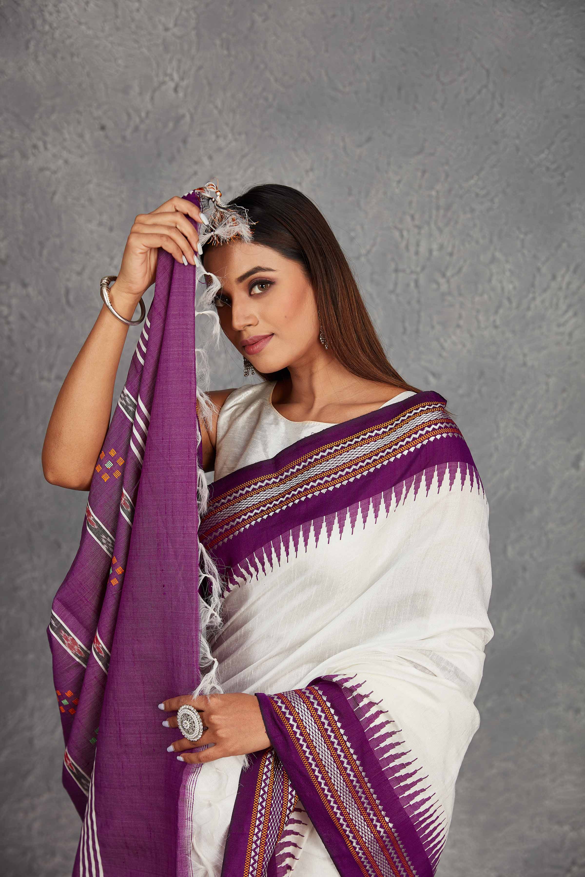 Shop white tussar silk sari online in USA with purple border and pallu. Get festive ready in beautiful Kanchipuram silk saris, pure silk sarees, soft silk sarees, tussar silk saris, handwoven sarees, chanderi silk sarees from Pure Elegance Indian fashion store in USA.-closeup