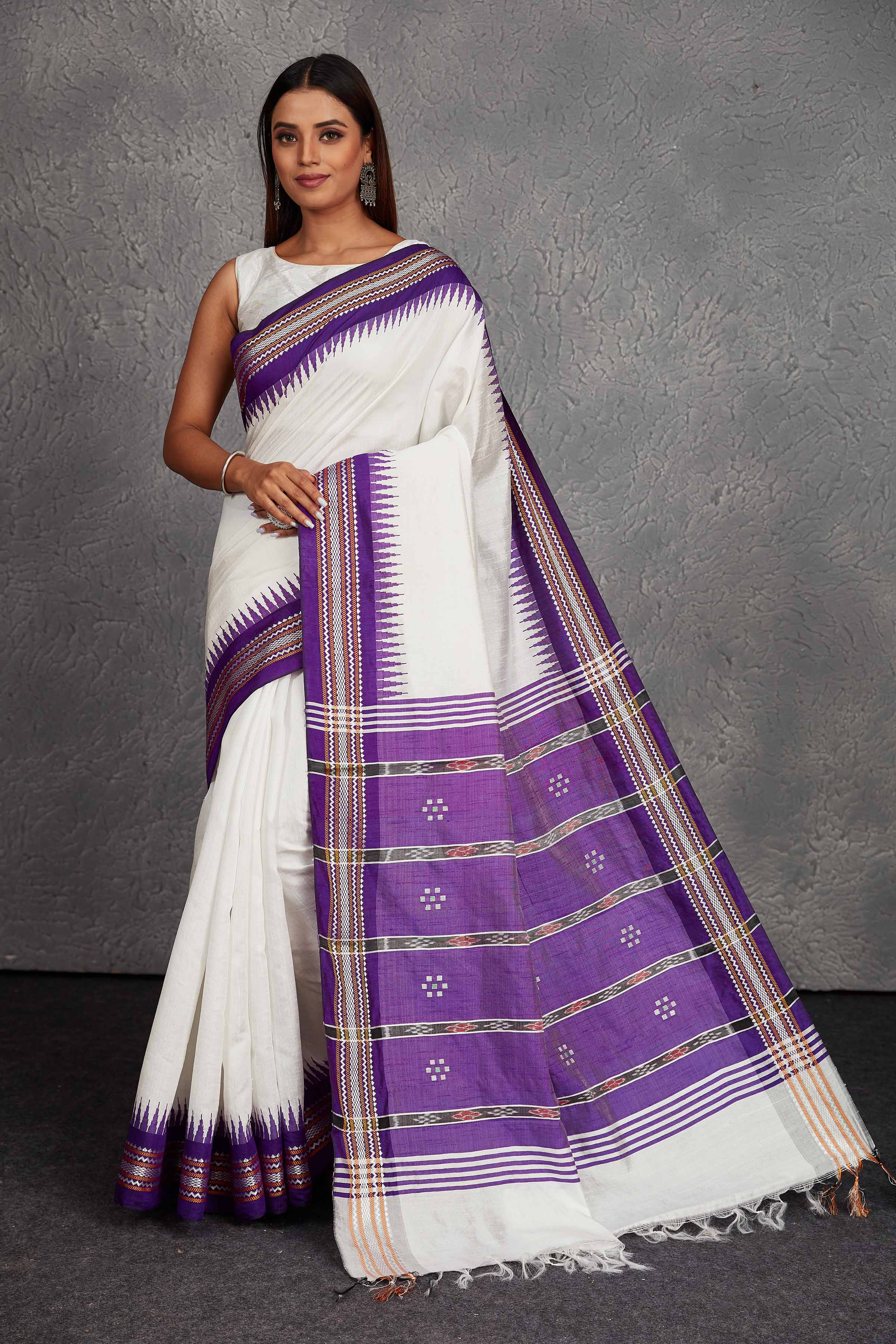 Shop white tussar silk saree online in USA with purple border and pallu. Get festive ready in beautiful Kanchipuram silk saris, pure silk sarees, soft silk sarees, tussar silk saris, handwoven sarees, chanderi silk sarees from Pure Elegance Indian fashion store in USA.-full view