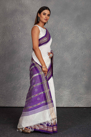 Shop white tussar silk saree online in USA with purple border and pallu. Get festive ready in beautiful Kanchipuram silk saris, pure silk sarees, soft silk sarees, tussar silk saris, handwoven sarees, chanderi silk sarees from Pure Elegance Indian fashion store in USA.-side
