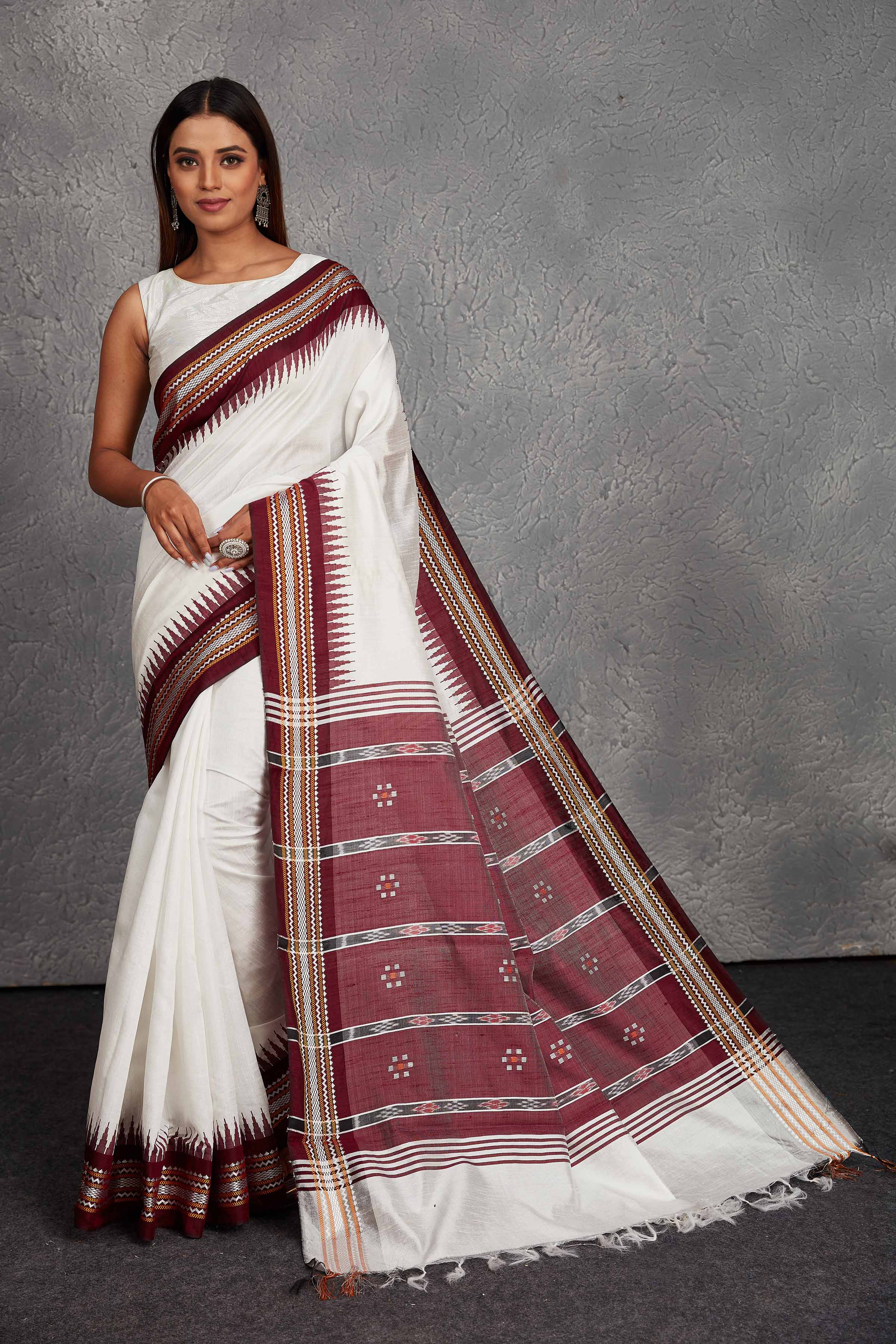 Shop elegant white tussar silk saree online in USA with maroon border and pallu. Get festive ready in beautiful Kanchipuram silk saris, pure silk sarees, soft silk sarees, tussar silk saris, handwoven sarees, chanderi silk sarees from Pure Elegance Indian fashion store in USA.-full view