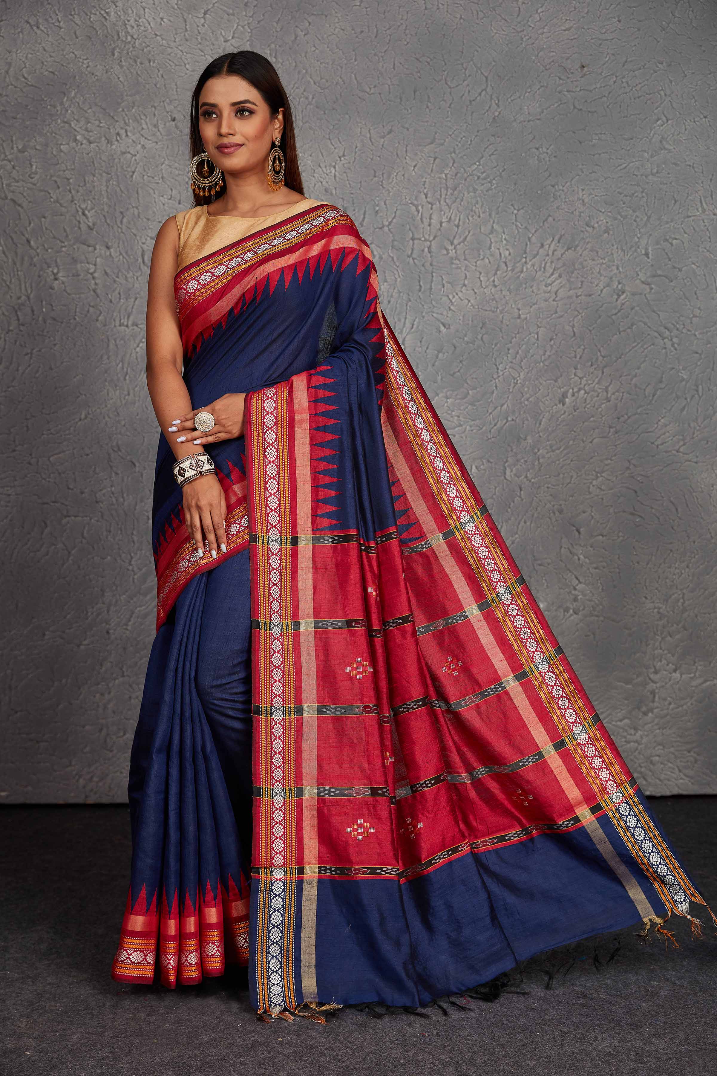 Buy navy blue tussar silk saree online in USA with red temple border and pallu. Get festive ready in beautiful Kanchipuram silk saris, pure silk sarees, soft silk sarees, tussar silk saris, handwoven sarees, chanderi silk sarees from Pure Elegance Indian fashion store in USA.-full view