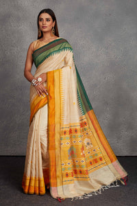 Shop cream tussar silk saree online in USA with green and yellow border. Get festive ready in beautiful Kanchipuram silk saris, pure silk sarees, soft silk sarees, tussar silk saris, handwoven sarees, chanderi silk sarees from Pure Elegance Indian fashion store in USA.-full view