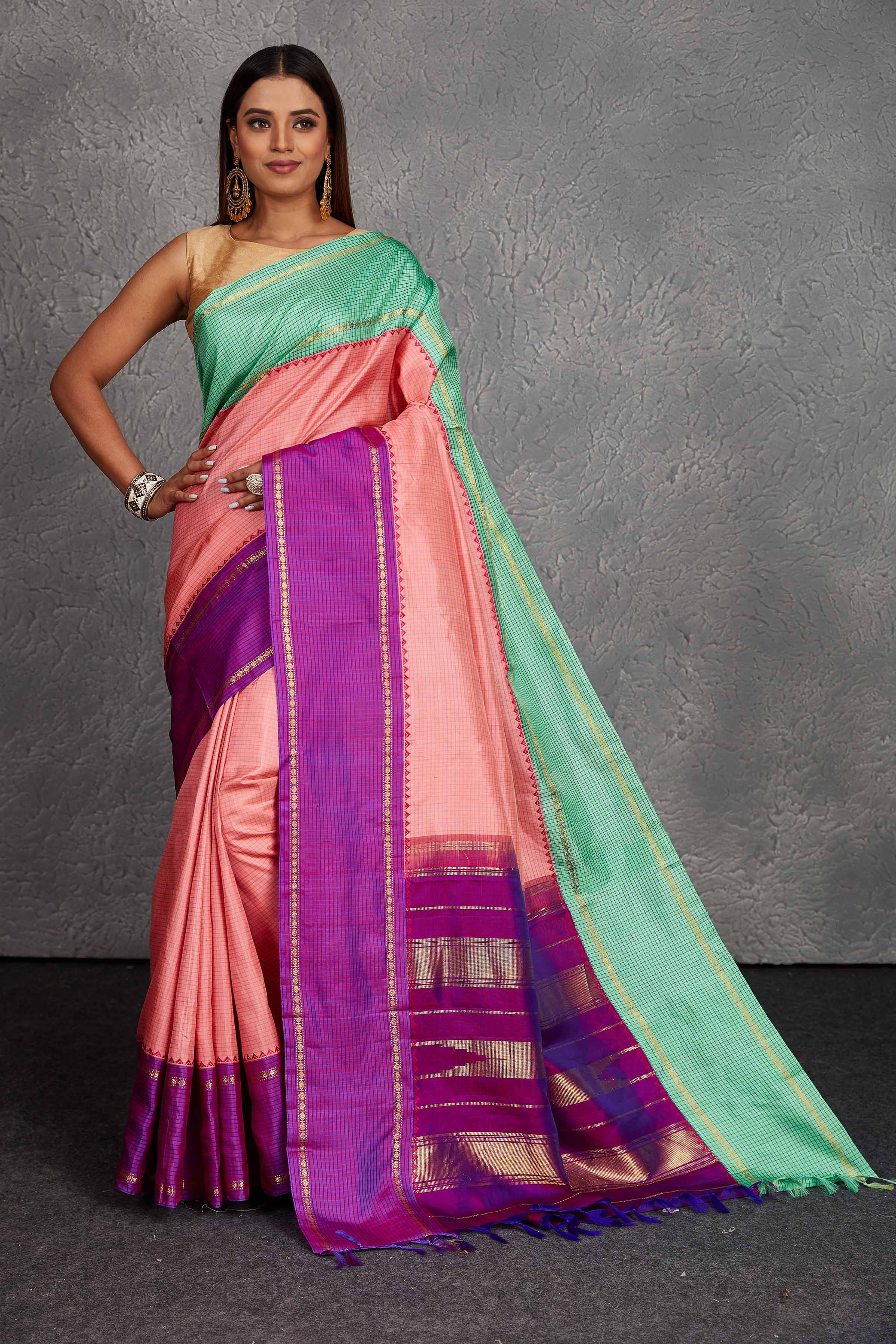Buy beautiful light pink Kanchirpuram silk sari online in USA with green and purple border. Get festive ready in beautiful Kanchipuram silk saris, pure silk sarees, soft silk sarees, tussar silk saris, handwoven sarees, chanderi silk sarees from Pure Elegance Indian fashion store in USA.-full view