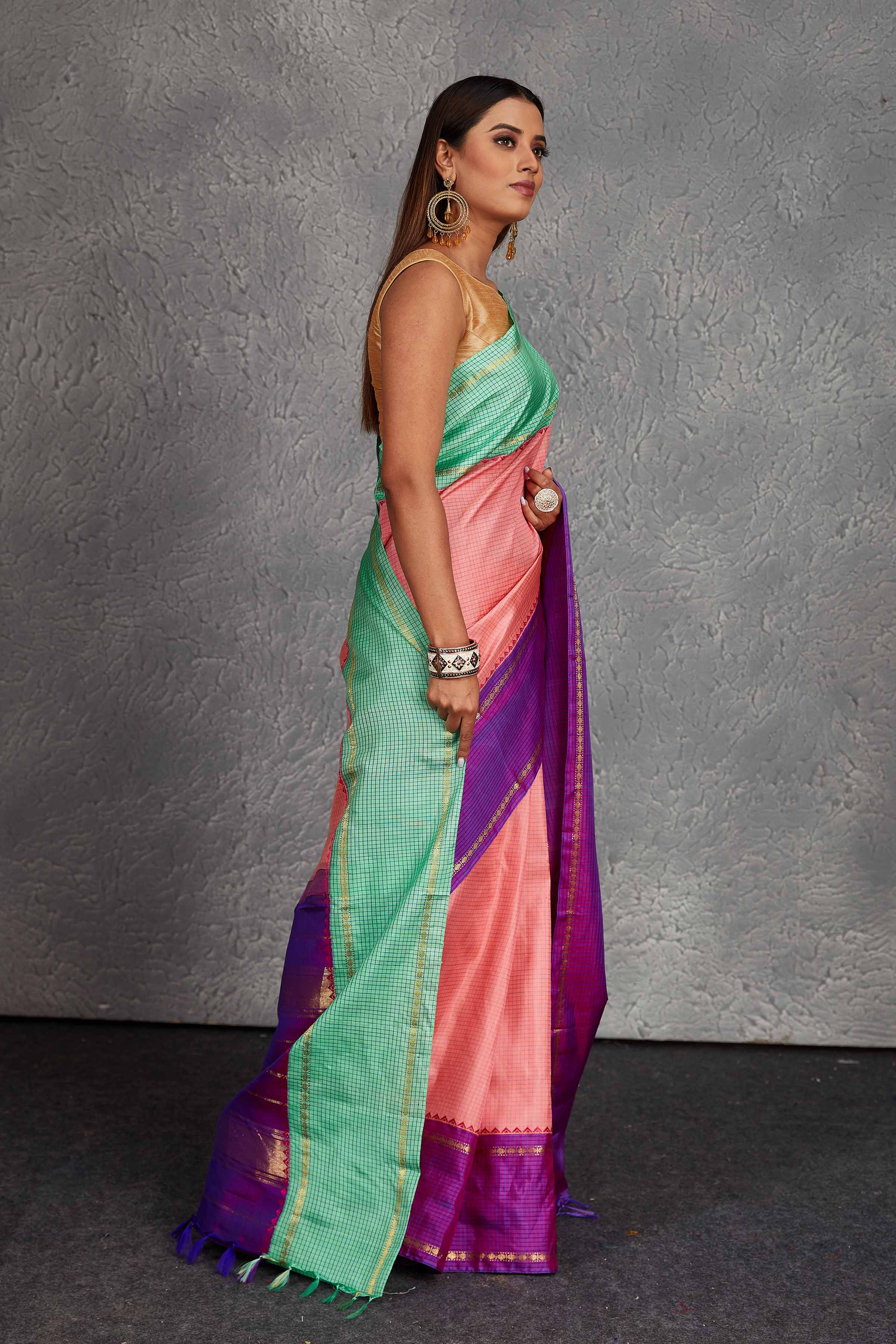 Buy beautiful light pink Kanchirpuram silk sari online in USA with green and purple border. Get festive ready in beautiful Kanchipuram silk saris, pure silk sarees, soft silk sarees, tussar silk saris, handwoven sarees, chanderi silk sarees from Pure Elegance Indian fashion store in USA.-side