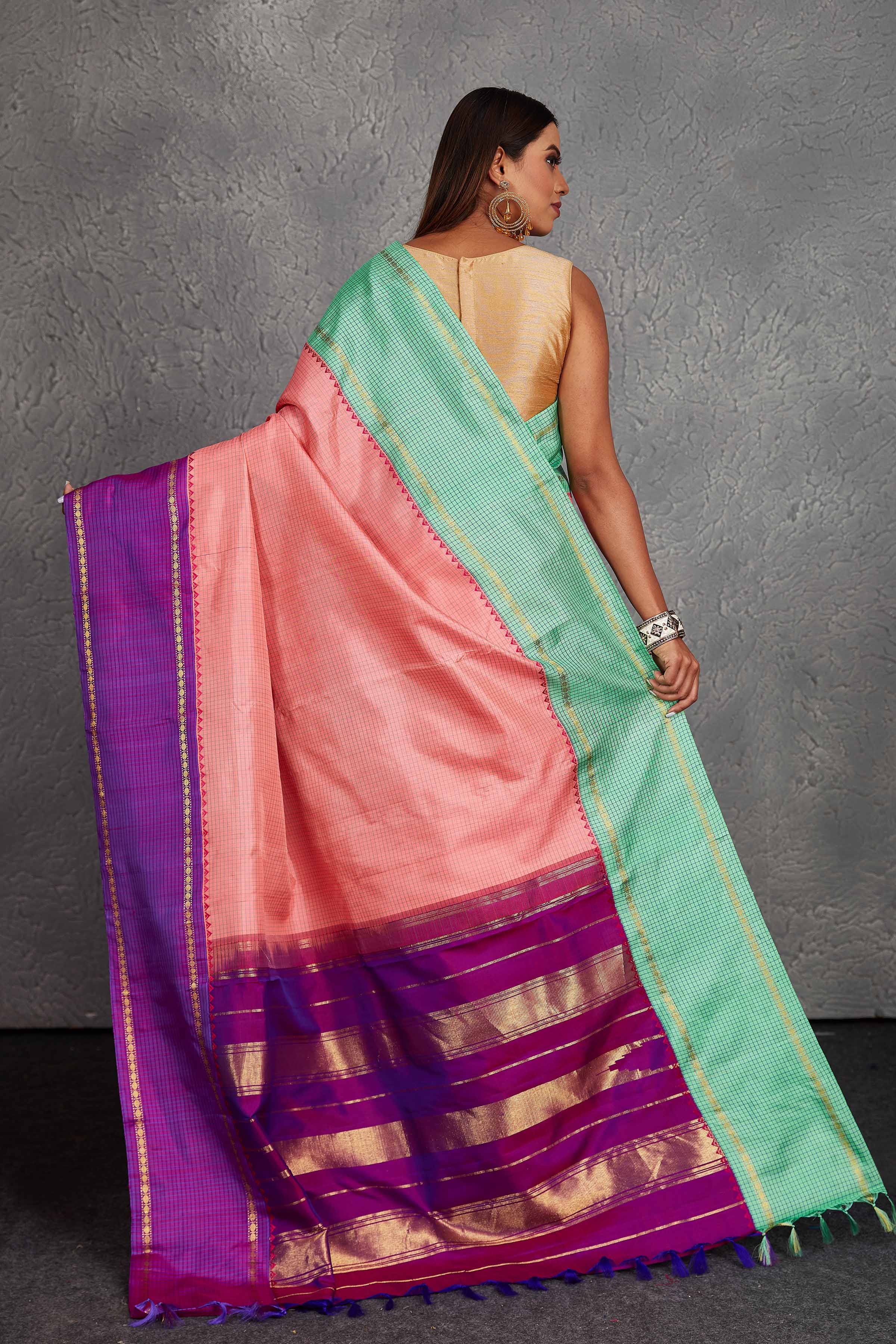 Buy beautiful light pink Kanchirpuram silk sari online in USA with green and purple border. Get festive ready in beautiful Kanchipuram silk saris, pure silk sarees, soft silk sarees, tussar silk saris, handwoven sarees, chanderi silk sarees from Pure Elegance Indian fashion store in USA.-back