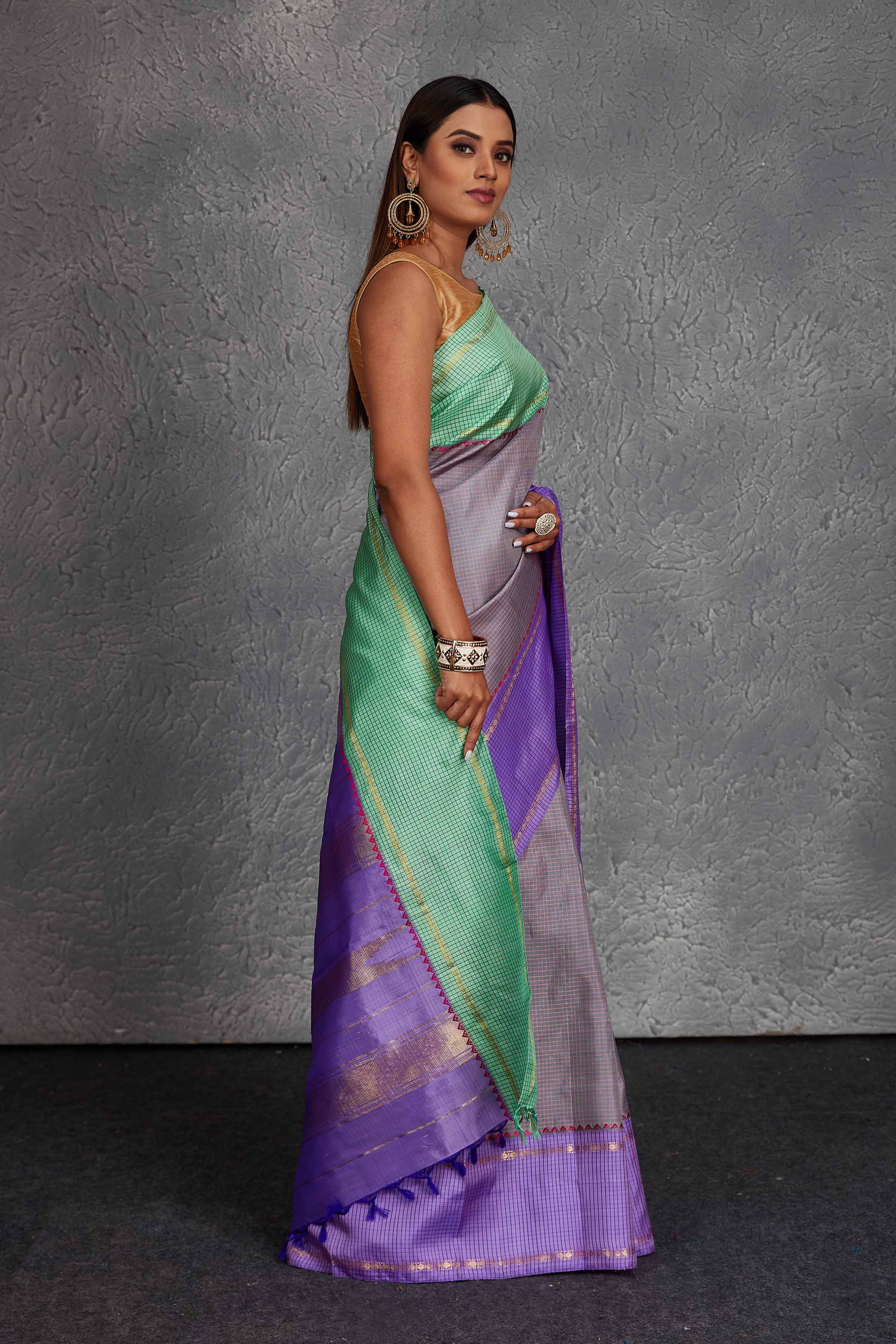 Buy beautiful grey Kanchirpuram silk sari online in USA with lavender and green border. Get festive ready in beautiful Kanchipuram silk saris, pure silk sarees, soft silk sarees, tussar silk saris, handwoven sarees, chanderi silk sarees from Pure Elegance Indian fashion store in USA.-side