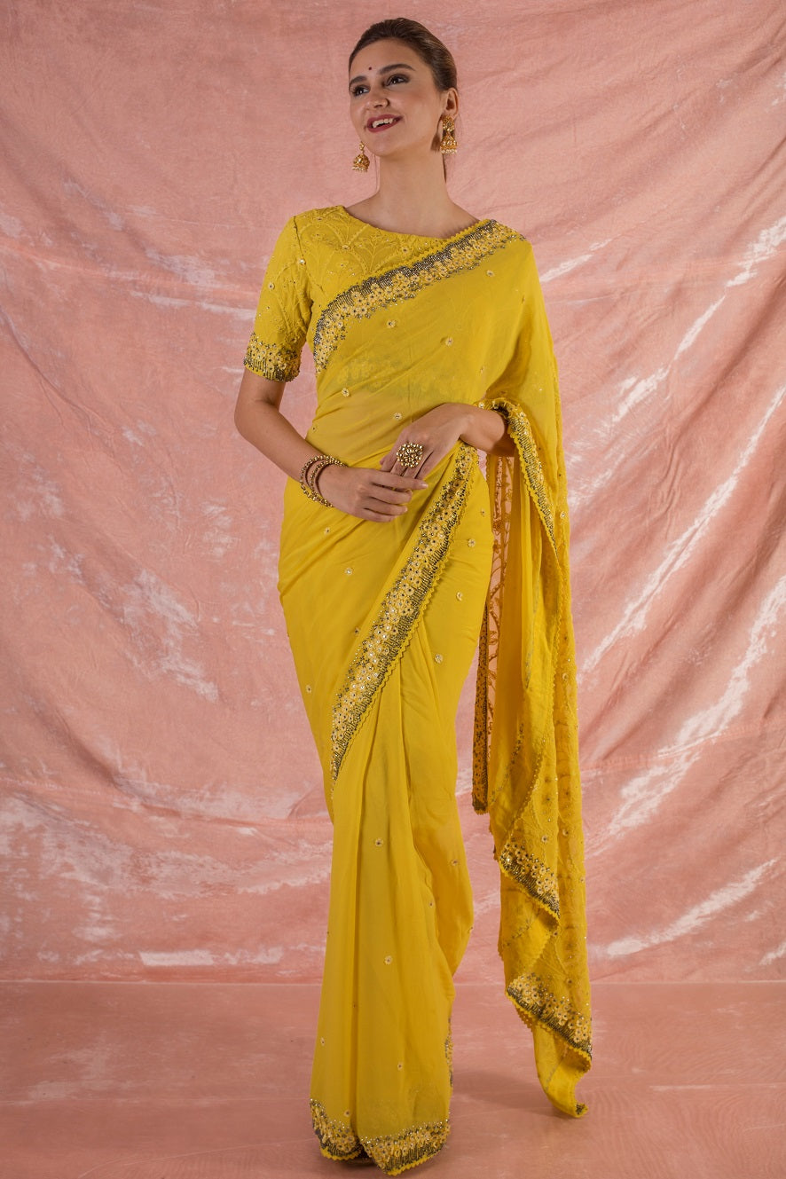 Buy beautiful yellow embroidered georgette saree online in USA.Saree crafted with fine embroidery and simple grey/yellow border.Golden blouse has detailed border around waist and sleeves. Be the talk of parties and weddings with exquisite designer sarees from Pure Elegance Indian clothing store in USA.Shop online now.-full view
