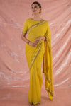 Buy beautiful yellow embroidered georgette saree online in USA.Saree crafted with fine embroidery and simple grey/yellow border.Golden blouse has detailed border around waist and sleeves. Be the talk of parties and weddings with exquisite designer sarees from Pure Elegance Indian clothing store in USA.Shop online now.-full view