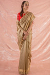 Buy brown embroidered handloom saree online in USA. Saree has fine design of checks and heavy border. Blouse of red color has detailed embroidery around neck and printed design on sleeves. Be the talk of parties and weddings with exquisite designer sarees from Pure Elegance Indian clothing store in USA.Shop online now.-full view