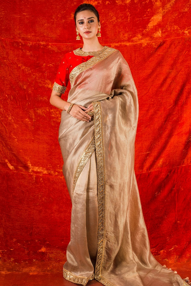 Buy gold embroidered handloom saree online in USA. Saree has fine work and heavy yet simple golden border. Red blouse has heavy embroidery work around neck and sleeves and of elbow lenght. Be the talk of parties and weddings with exquisite designer sarees from Pure Elegance Indian clothing store in USA.Shop online now.-full view