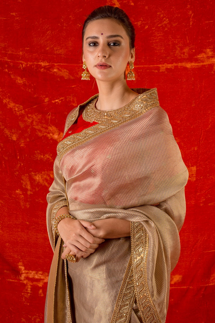Buy gold embroidered handloom saree online in USA. Saree has fine work and heavy yet simple golden border. Red blouse has heavy embroidery work around neck and sleeves and of elbow lenght. Be the talk of parties and weddings with exquisite designer sarees from Pure Elegance Indian clothing store in USA.Shop online now.-close up