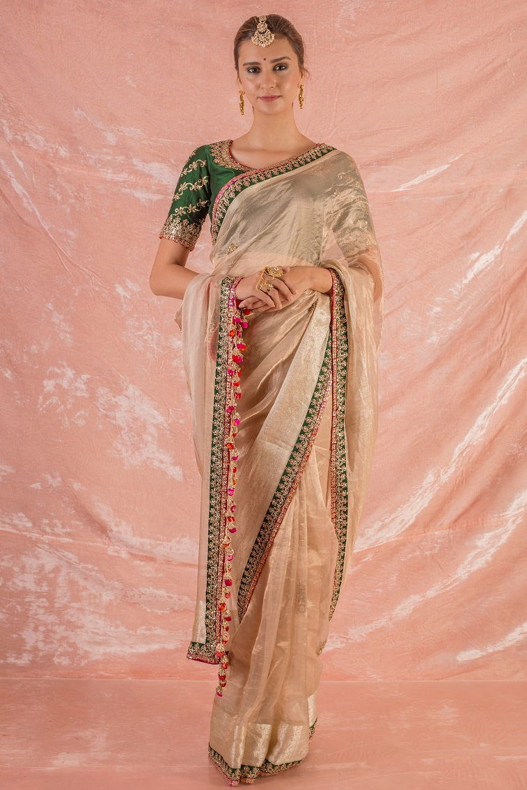 Buy gold embroidered handloom saree online in USA. Saree has fine work and green border with golden work. Pallu has red latknas. Green blouse has heavy embroidery and its of elbow length. Be the talk of parties and weddings with exquisite designer sarees from Pure Elegance Indian clothing store in USA.Shop online now.-full view