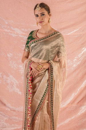 Buy gold embroidered handloom saree online in USA. Saree has fine work and green border with golden work. Pallu has red latknas. Green blouse has heavy embroidery and its of elbow length. Be the talk of parties and weddings with exquisite designer sarees from Pure Elegance Indian clothing store in USA.Shop online now.-close up