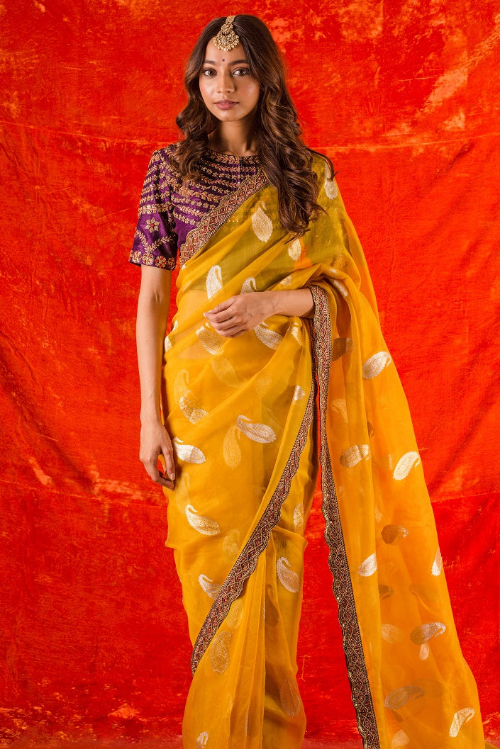 Buy beautiful bright yellow embroidered organza saree online in USA. it comes with purple embroidered saree blouse. This elegant piece gets it look from its heavy border. Be the talk of parties and weddings with exquisite designer sarees  from Pure Elegance Indian clothing store in USA. Shop online now.-full view