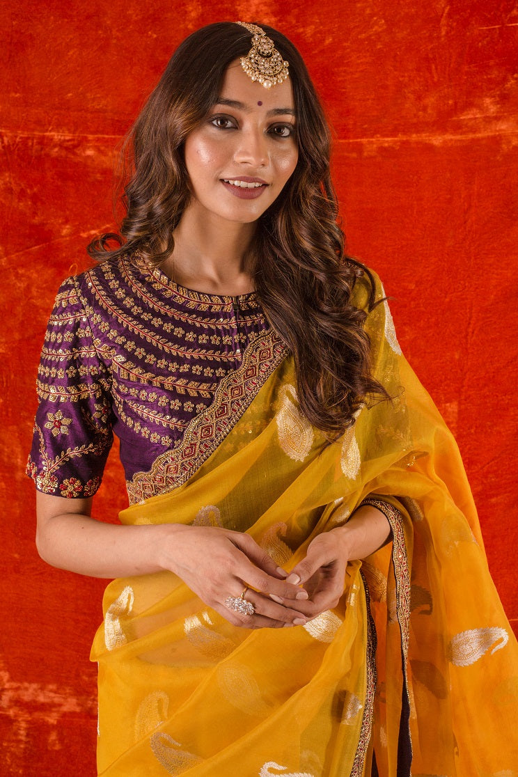 Buy beautiful bright yellow embroidered organza saree online in USA. it comes with purple embroidered saree blouse. This elegant piece gets it look from its heavy border. Be the talk of parties and weddings with exquisite designer sarees  from Pure Elegance Indian clothing store in USA. Shop online now.-close up