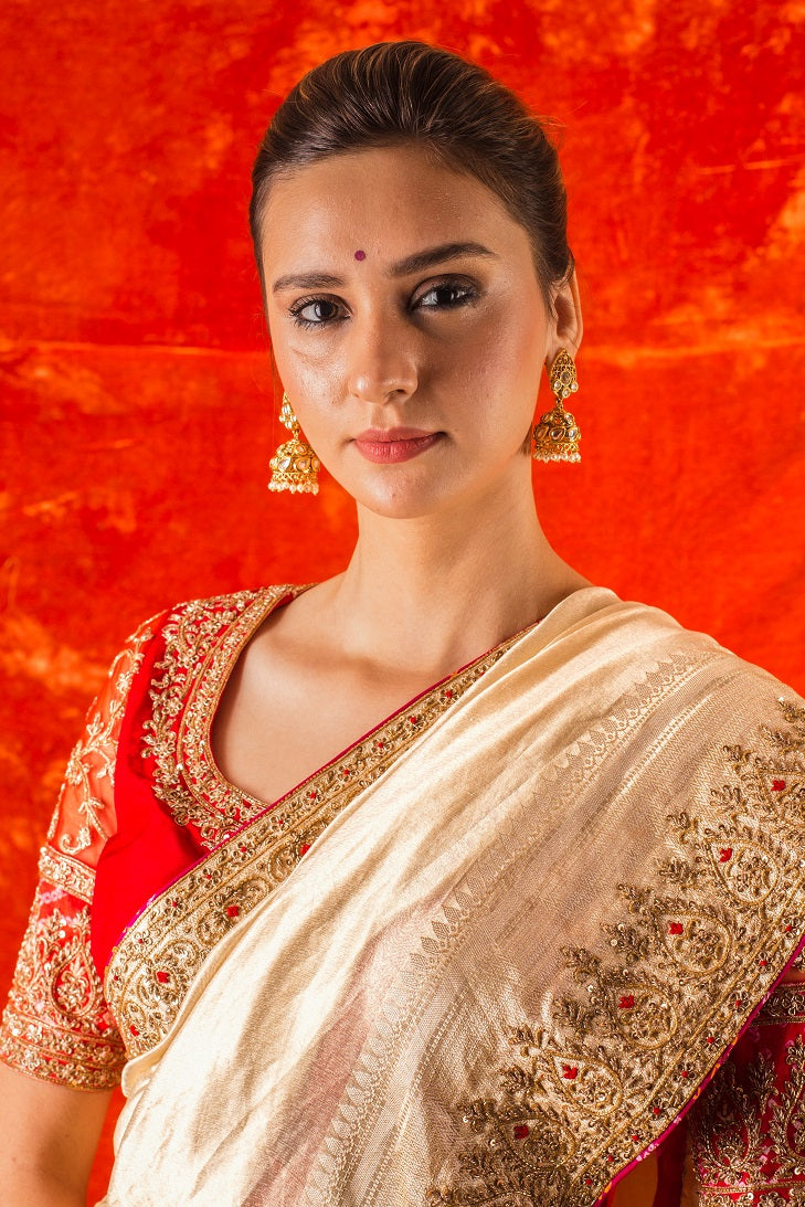Buy beautiful golden embroidered handloom saree online in USA. Saree is crafted with fine embroidery and thick heavy border. saree comes with red colored blouse. Be the talk of parties and weddings with exquisite designer sarees from Pure Elegance Indian clothing store in USA.Shop online now.-close up