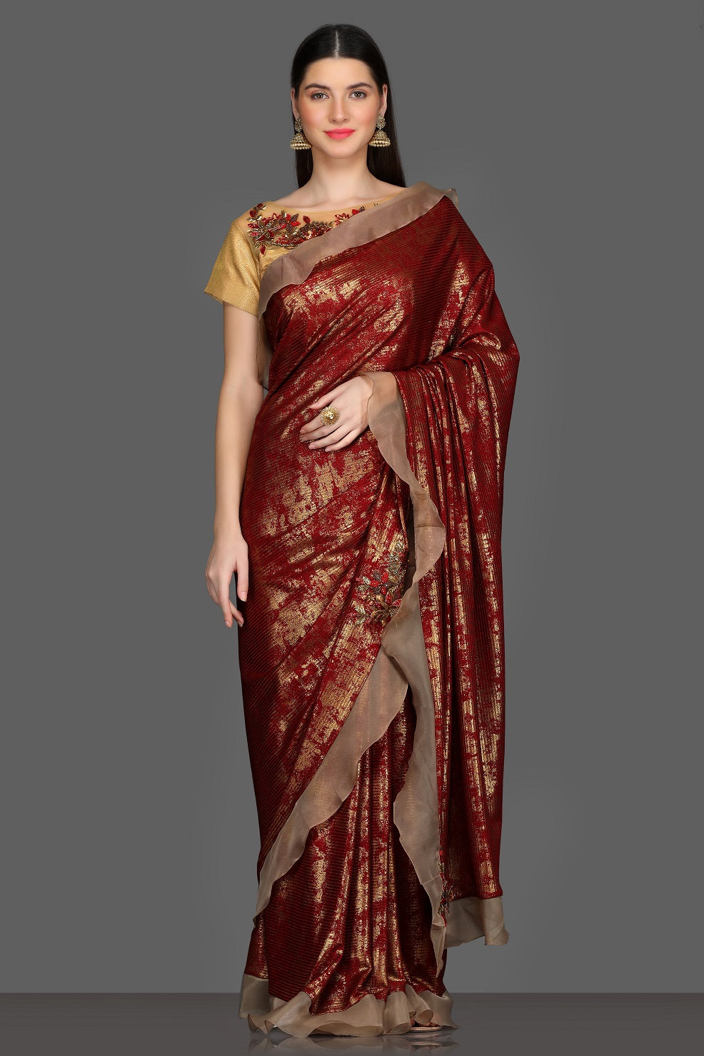 Shop gorgeous maroon and golden fancy ruffle saree online in USA with golden embroidered saree blouse. Make a fashion statement at weddings with stunning designer sarees, embroidered sarees with blouse, wedding sarees, handloom sarees from Pure Elegance Indian fashion store in USA.-full view