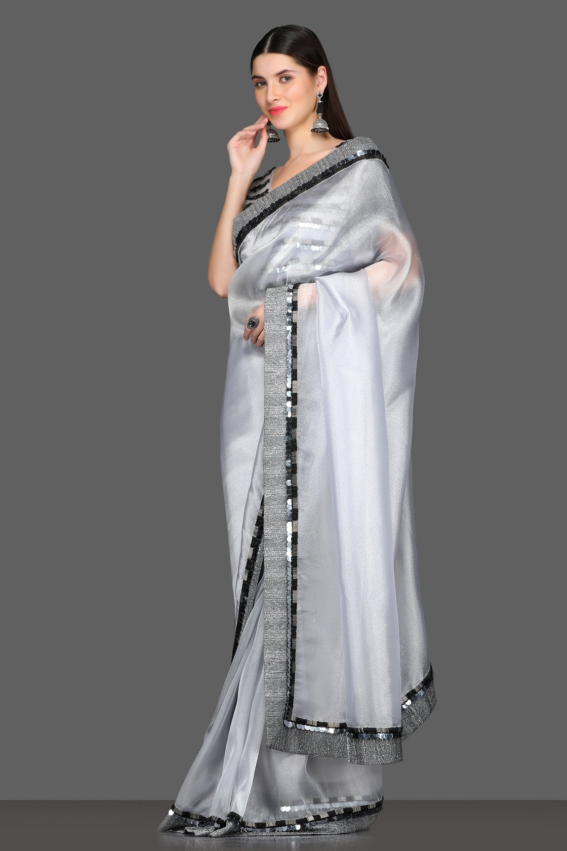 Shop light grey embellished designer saree online in USA with saree blouse. Make a fashion statement at weddings with stunning designer sarees, embroidered sarees with blouse, wedding sarees, handloom sarees from Pure Elegance Indian fashion store in USA.-side