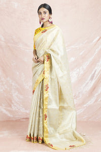 Buy beautiful cream embroidered handloom saree online in USA with embroidered yellow sari blouse. Champion ethnic fashion on weddings and festivals with a stunning collection of Banarasi sarees, handloom sarees with blouse, bridal sarees, from Pure Elegance Indian fashion store in USA.-full view