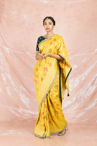 Buy beautiful yellow color embroidered handloom saree online in USA with embroidered green saree blouse. Champion ethnic fashion on weddings and festivals with a stunning collection of Banarasi sarees, handloom sarees with blouse, bridal sarees, from Pure Elegance Indian fashion store in USA.-full view