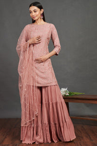 Buy beautiful blush pink embroidered sharara suit online in USA with dupatta. Make a fashion statement on festive occasions and weddings with designer suits, Indian dresses, Anarkali suits, palazzo suits, designer gowns, sharara suits from Pure Elegance Indian fashion store in USA.-full view