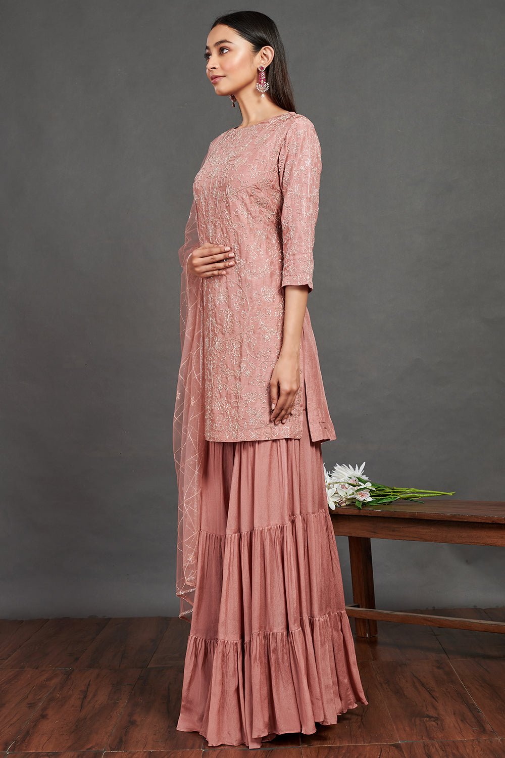 Buy beautiful blush pink embroidered sharara suit online in USA with dupatta. Make a fashion statement on festive occasions and weddings with designer suits, Indian dresses, Anarkali suits, palazzo suits, designer gowns, sharara suits from Pure Elegance Indian fashion store in USA.-side