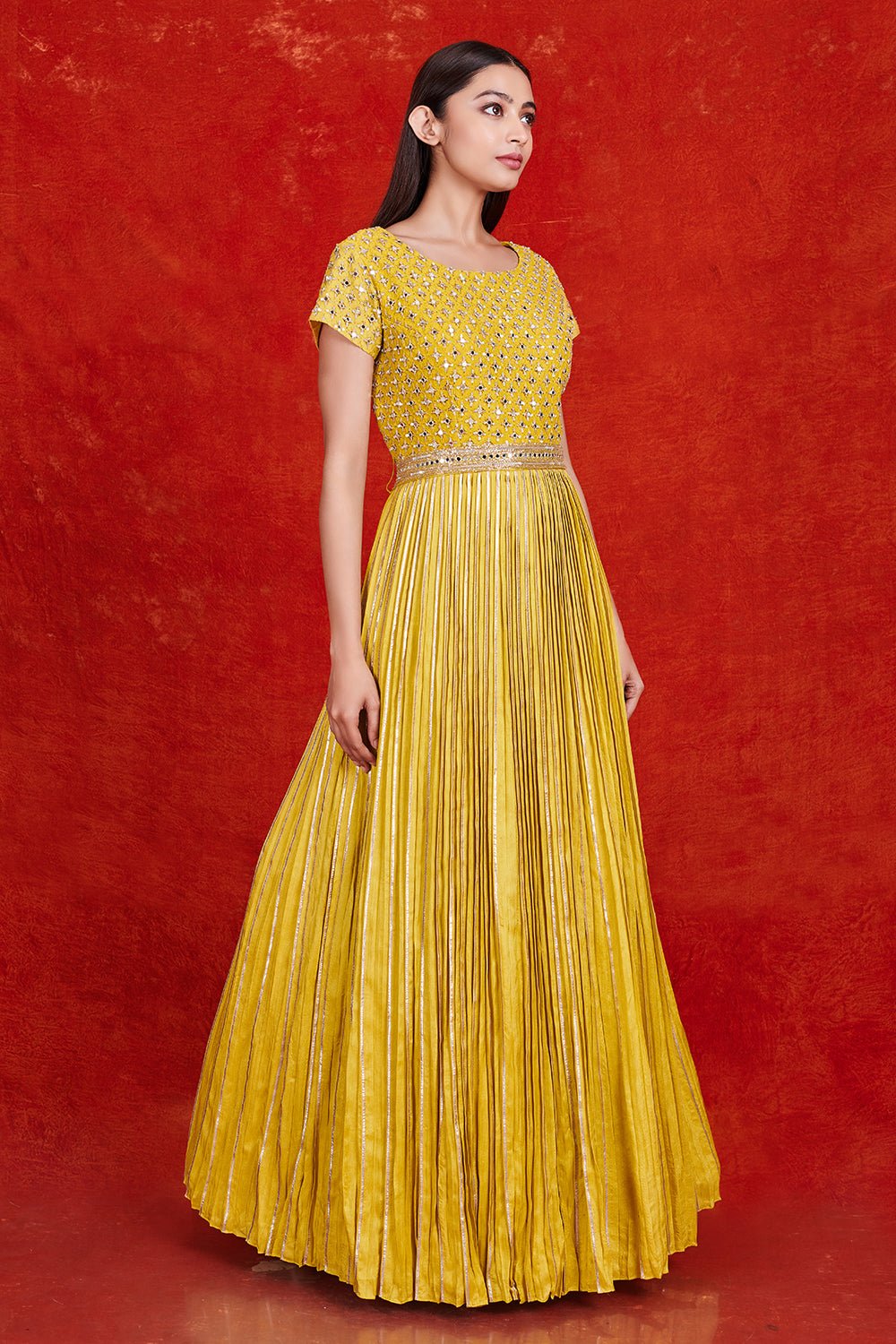 Buy gorgeous yellow fit and flare mirror work gown online in USA. Make a fashion statement on festive occasions and weddings with designer suits, Indian dresses, Anarkali suits, palazzo suits, designer gowns, sharara suits from Pure Elegance Indian fashion store in USA.-right