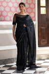 Shop a beautiful black sequin embroidered saree. It comes with a sequined work all over, a bootcut neck, and a sleeveless sequined blouse. It is best suited for night parties & weddings. Make a fashion statement on festive occasions and weddings with designer sarees, designer suits, Indian dresses, Anarkali suits, palazzo suits, designer gowns, sharara suits, and embroidered sarees from Pure Elegance Indian fashion store in USA.
