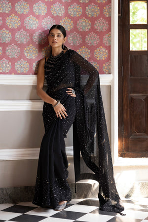 Shop a Beautiful black sequin embroidered saree. It comes with a sequined work all over and a sleeveless sequined blouse. It is best suited for night parties & weddings.  Make a fashion statement on festive occasions and weddings with designer sarees, designer suits, Indian dresses, Anarkali suits, palazzo suits, designer gowns, sharara suits, and embroidered sarees from Pure Elegance Indian fashion store in the USA.