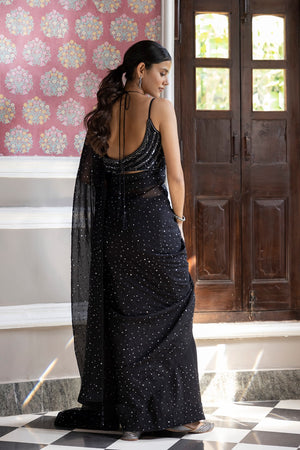 Shop a Beautiful black sequin embroidered saree. It comes with a sequined work all over and a sleeveless sequined blouse. It is best suited for night parties & weddings.  Make a fashion statement on festive occasions and weddings with designer sarees, designer suits, Indian dresses, Anarkali suits, palazzo suits, designer gowns, sharara suits, and embroidered sarees from Pure Elegance Indian fashion store in the USA.