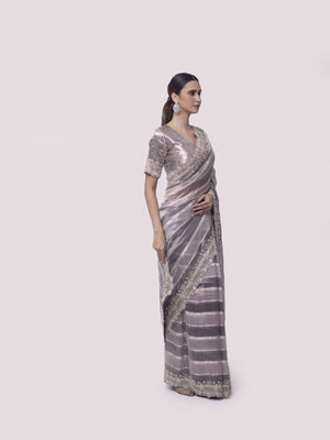 Buy beautiful two-tone silver embroidered handloom saree online in USA with blouse. Make a fashion statement on festive occasions and weddings with designer sarees, designer suits, Indian dresses, Anarkali suits, palazzo suits, designer gowns, sharara suits, embroidered sarees from Pure Elegance Indian fashion store in USA.-right
