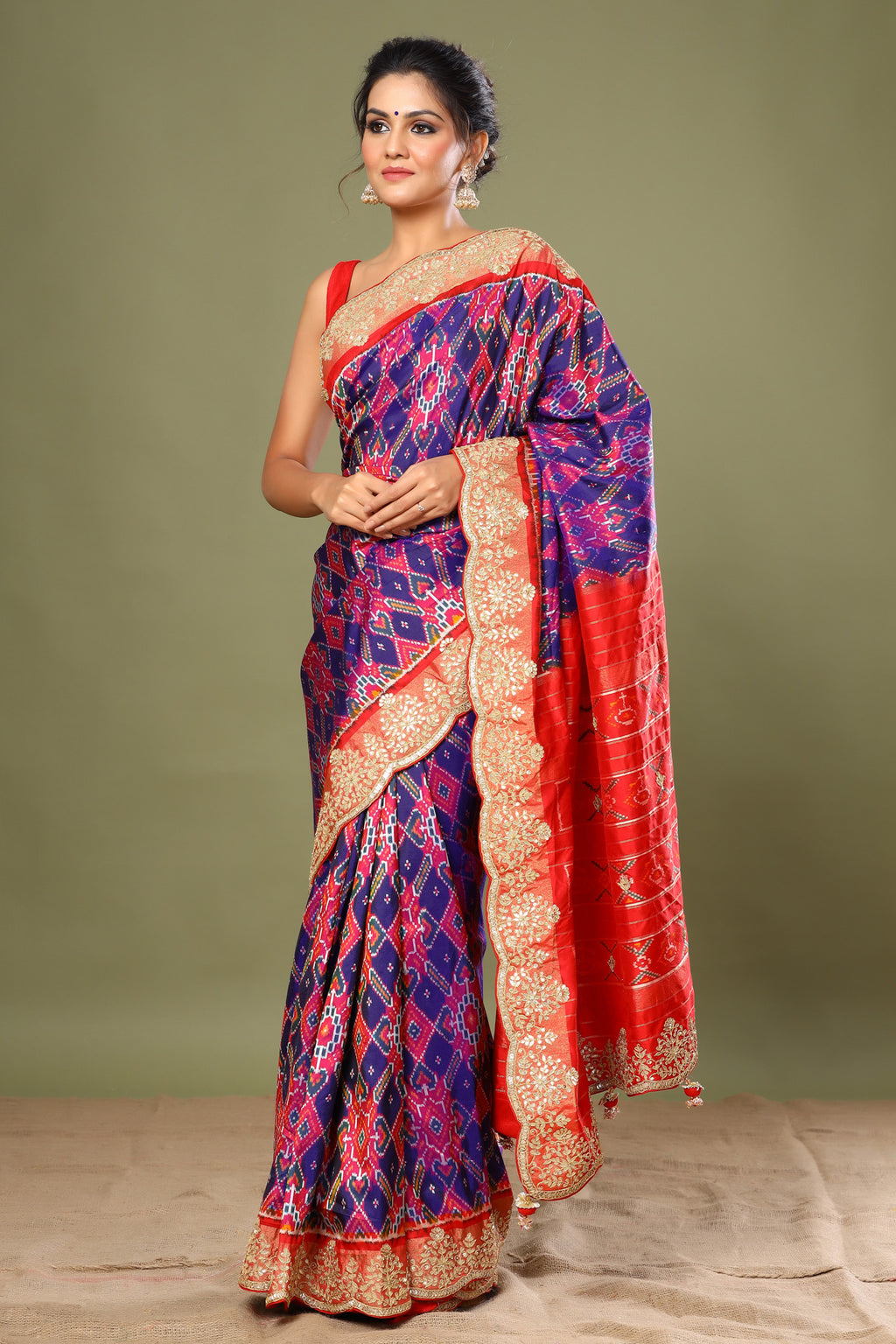 Buy purple Patola silk saree online in USA with red scalloped border. Make a fashion statement at weddings with stunning designer sarees, embroidered sarees with blouse, wedding sarees, handloom sarees from Pure Elegance Indian fashion store in USA.-full view