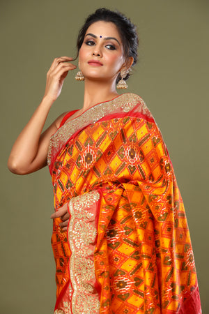 Shop orange Patola silk saree online in USA with scalloped border. Make a fashion statement at weddings with stunning designer sarees, embroidered sarees with blouse, wedding sarees, handloom sarees from Pure Elegance Indian fashion store in USA.-closeup