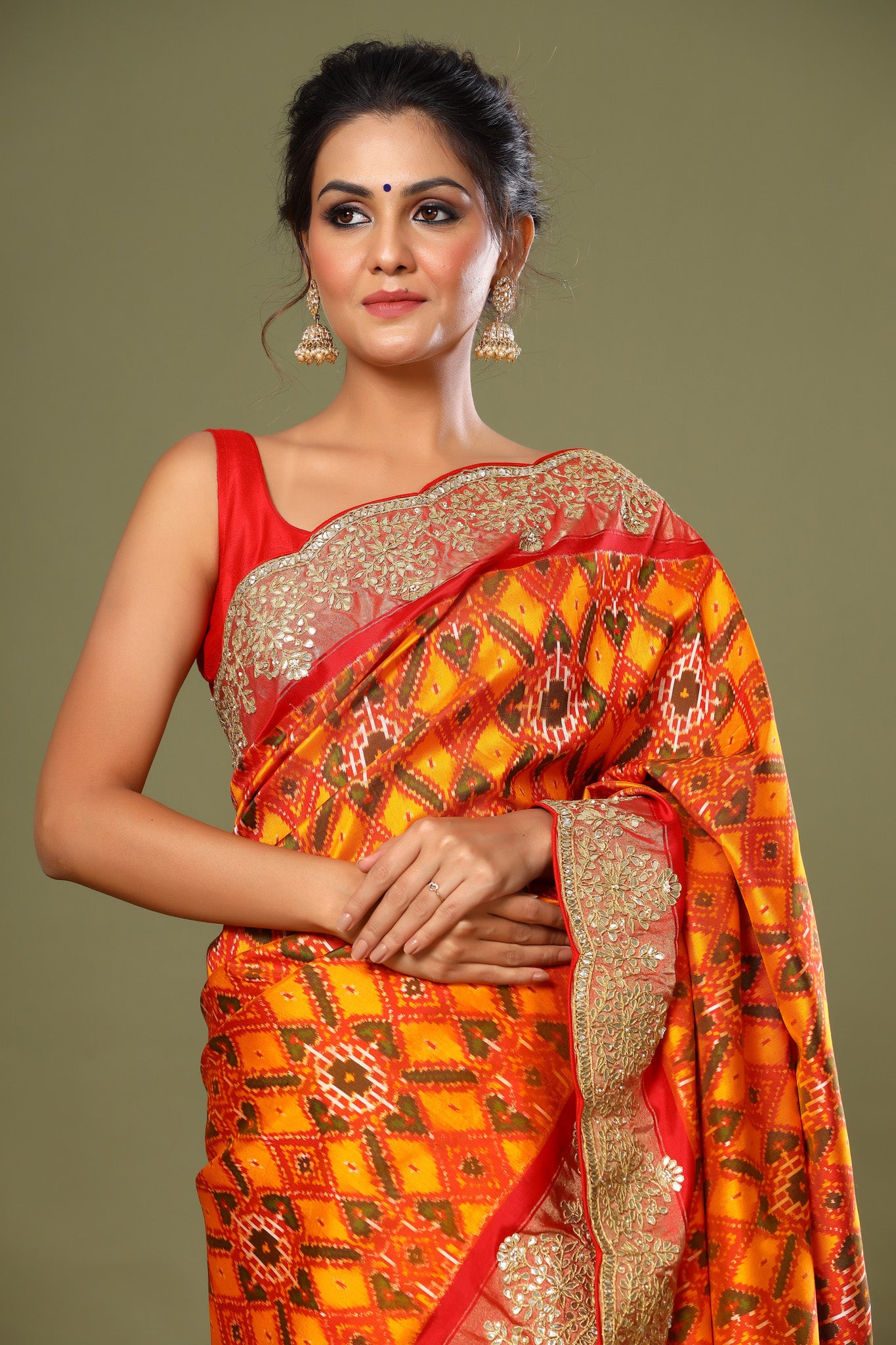 Shop orange Patola silk saree online in USA with scalloped border. Make a fashion statement at weddings with stunning designer sarees, embroidered sarees with blouse, wedding sarees, handloom sarees from Pure Elegance Indian fashion store in USA.-saree