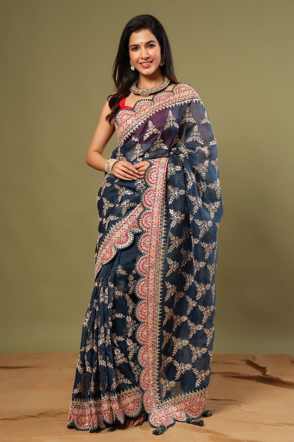 Buy sea green organza silk saree online in USA with red scalloped border. Make a fashion statement at weddings with stunning designer sarees, embroidered sarees with blouse, wedding sarees, handloom sarees from Pure Elegance Indian fashion store in USA.-full view