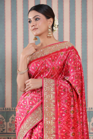 Buy pink Patola silk sari online in USA with embroidered border. Make a fashion statement at weddings with stunning designer sarees, embroidered sarees with blouse, wedding sarees, handloom sarees from Pure Elegance Indian fashion store in USA.-closeup