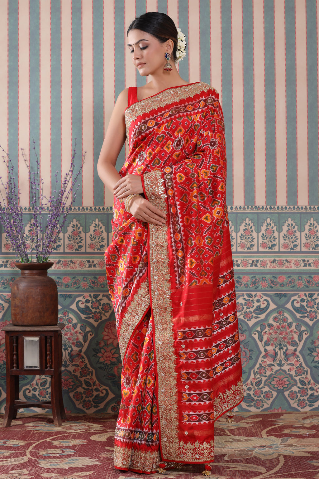 Shop red Patola silk sari online in USA with red embroidered border. Make a fashion statement at weddings with stunning designer sarees, embroidered sarees with blouse, wedding sarees, handloom sarees from Pure Elegance Indian fashion store in USA.-full view