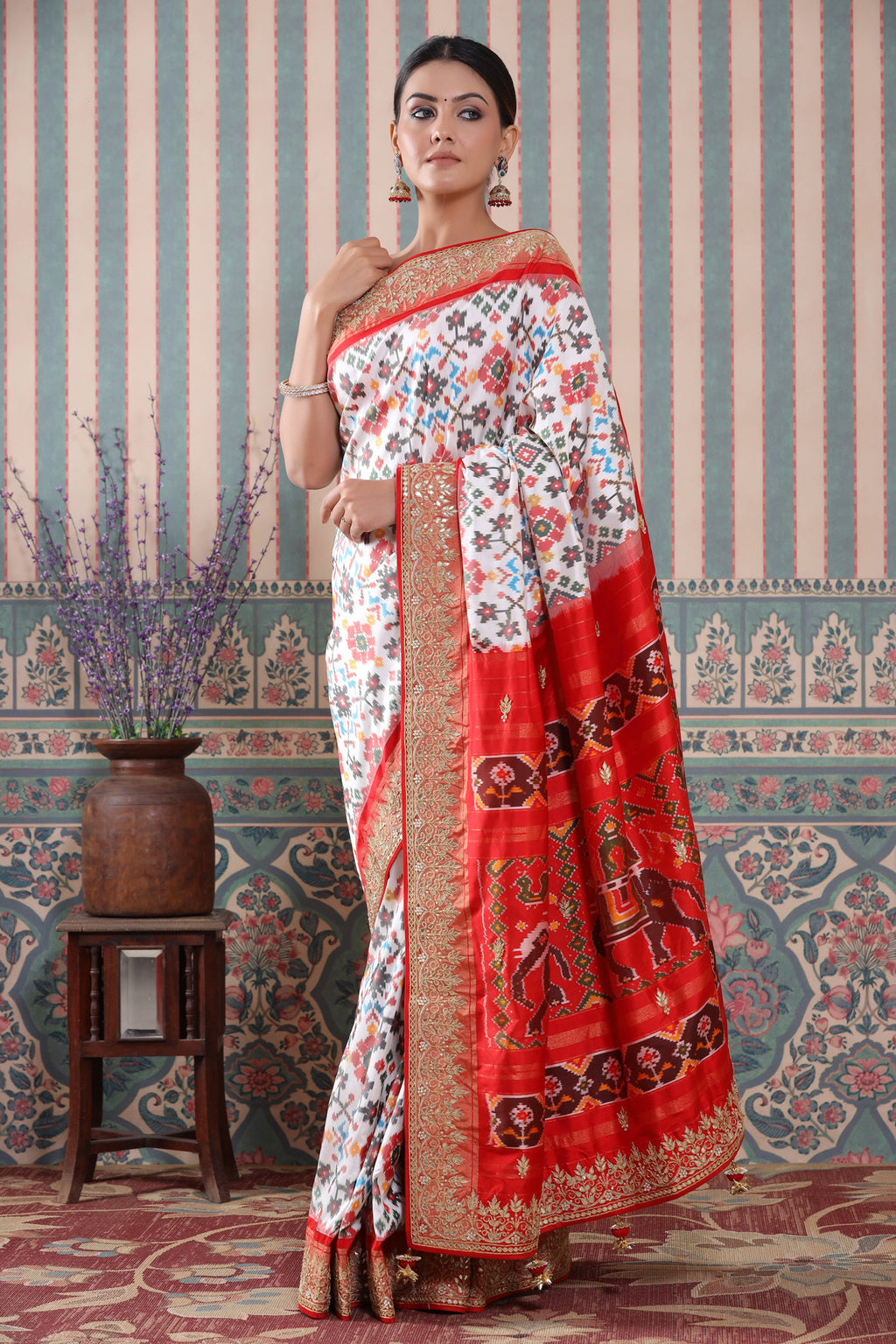 Shop white Patola silk sari online in USA with red embroidered border. Make a fashion statement at weddings with stunning designer sarees, embroidered sarees with blouse, wedding sarees, handloom sarees from Pure Elegance Indian fashion store in USA.-full view