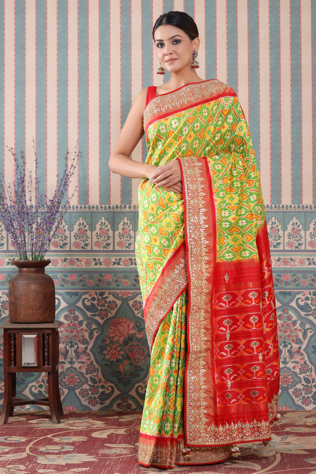Buy green Patola silk sari online in USA with red embroidered border. Make a fashion statement at weddings with stunning designer sarees, embroidered sarees with blouse, wedding sarees, handloom sarees from Pure Elegance Indian fashion store in USA.-full view