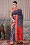 Shop blue Patola silk sari online in USA with red embroidered border. Make a fashion statement at weddings with stunning designer sarees, embroidered sarees with blouse, wedding sarees, handloom sarees from Pure Elegance Indian fashion store in USA.-full view