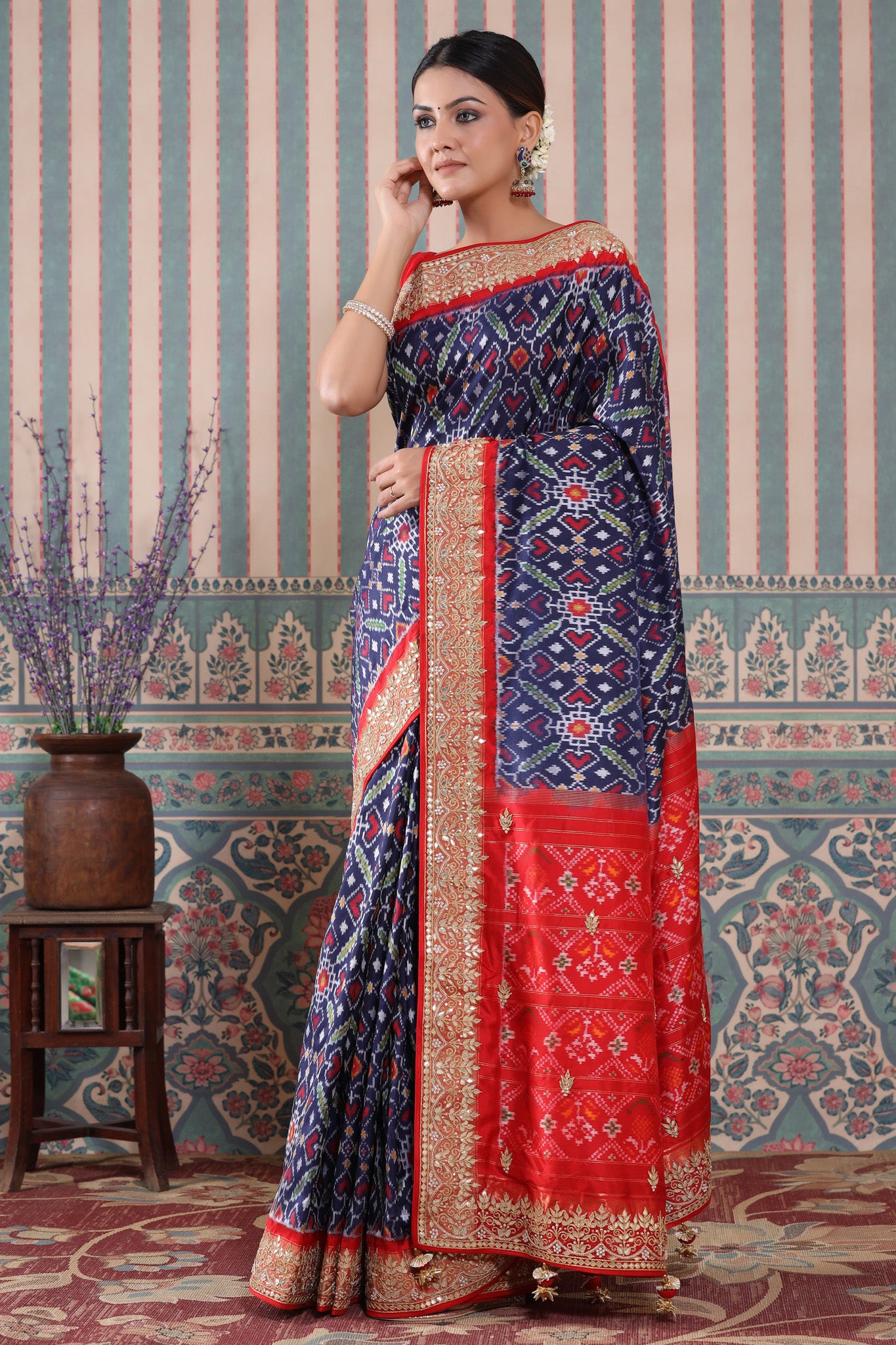 Shop blue Patola silk sari online in USA with red embroidered border. Make a fashion statement at weddings with stunning designer sarees, embroidered sarees with blouse, wedding sarees, handloom sarees from Pure Elegance Indian fashion store in USA.-pallu