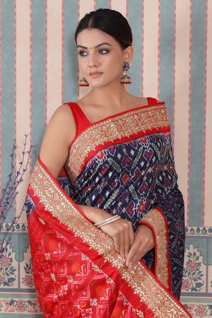 Shop blue Patola silk sari online in USA with red embroidered border. Make a fashion statement at weddings with stunning designer sarees, embroidered sarees with blouse, wedding sarees, handloom sarees from Pure Elegance Indian fashion store in USA.-saree
