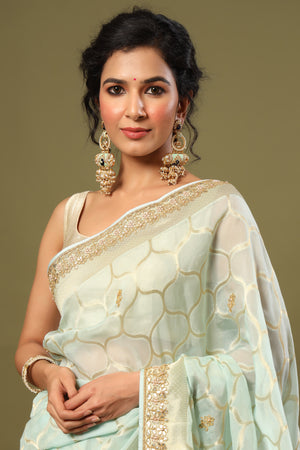 Shop mint green embroidered organza sari online in USA with zari jaal. Make a fashion statement at weddings with stunning designer sarees, embroidered sarees with blouse, wedding sarees, handloom sarees from Pure Elegance Indian fashion store in USA.-closeup