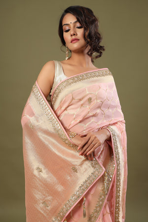 Buy light pink embroidered organza sari online in USA with zari jaal. Make a fashion statement at weddings with stunning designer sarees, embroidered sarees with blouse, wedding sarees, handloom sarees from Pure Elegance Indian fashion store in USA.-closeup