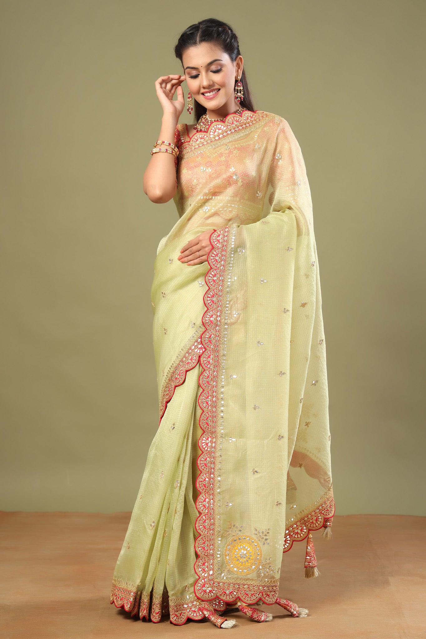 Shop pista green organza sari online in USA with red saree blouse. Make a fashion statement at weddings with stunning designer sarees, embroidered sarees with blouse, wedding sarees, handloom sarees from Pure Elegance Indian fashion store in USA.-front
