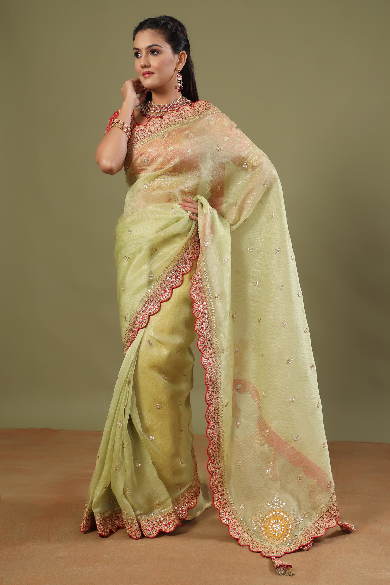 Shop pista green organza sari online in USA with red saree blouse. Make a fashion statement at weddings with stunning designer sarees, embroidered sarees with blouse, wedding sarees, handloom sarees from Pure Elegance Indian fashion store in USA.-pallu